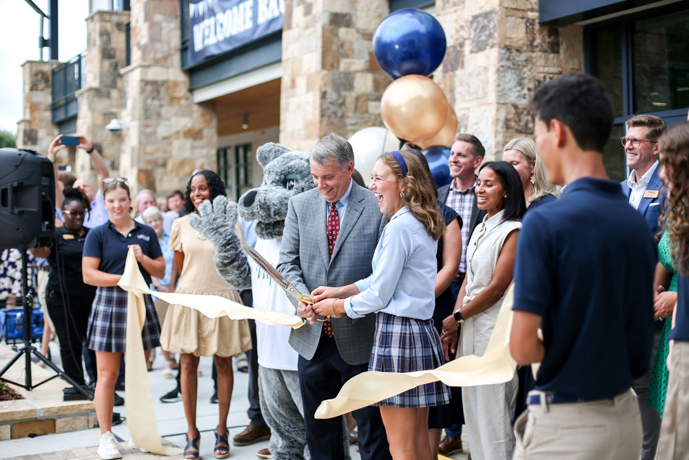 ribbon cutting group photo outside of learning commons